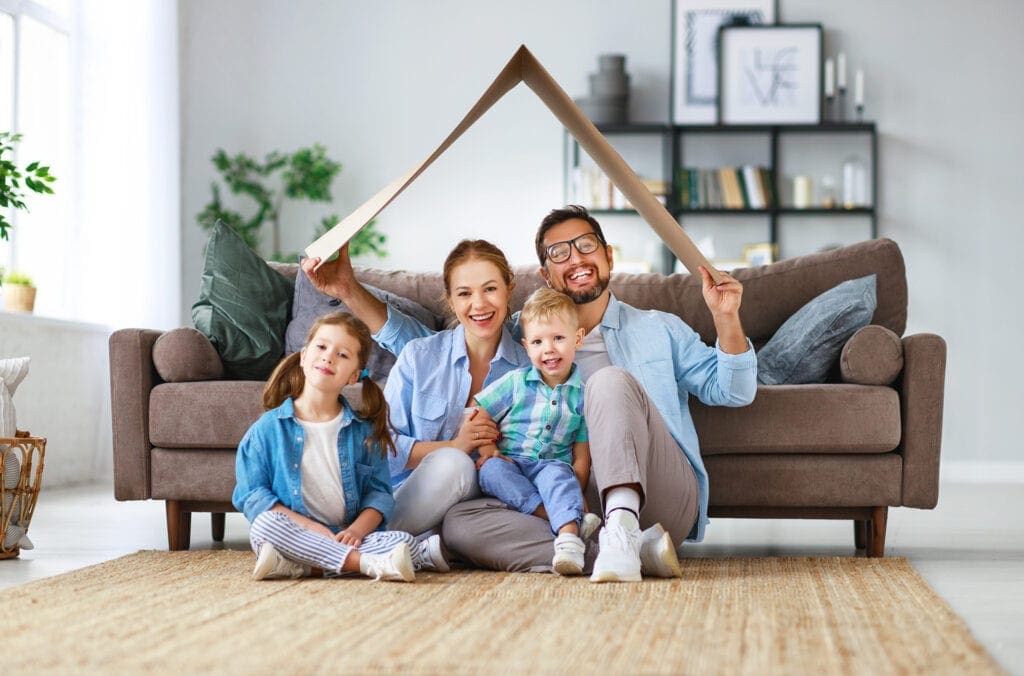 happy family mother father and kids with roof at a home happy family mother father and kids with roof at a home